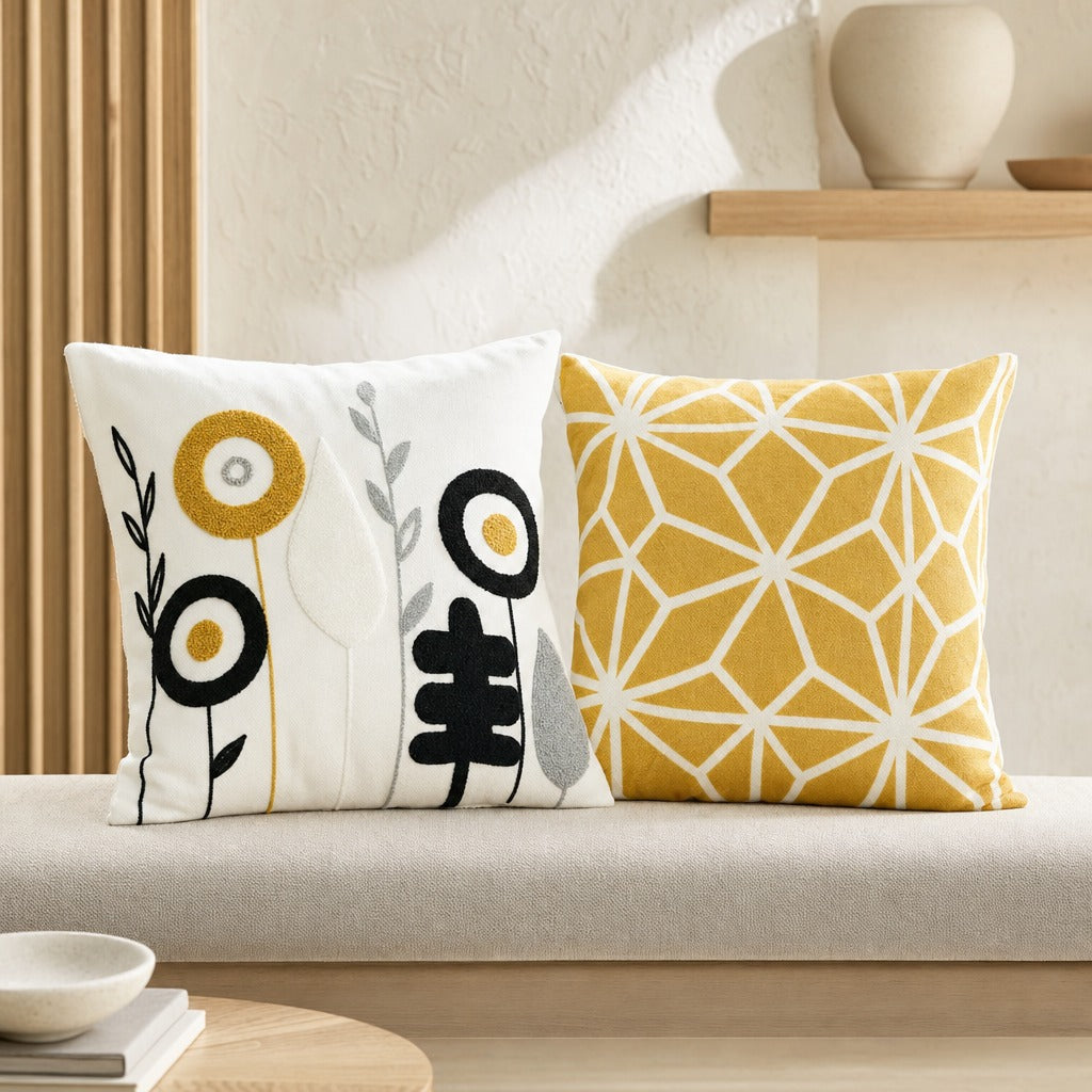 Blossoms ivory floral cushion cover paired with a mustard geometric cushion on a daybed