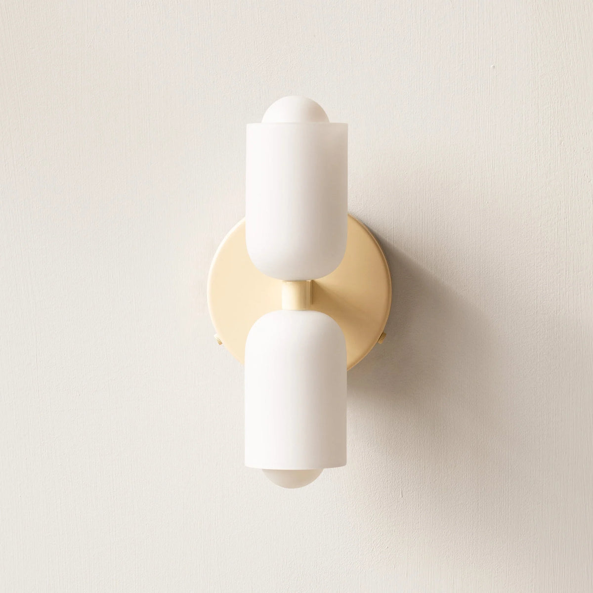 Boni up and down wall light with a beige wall plate and two white scalloped opal shades