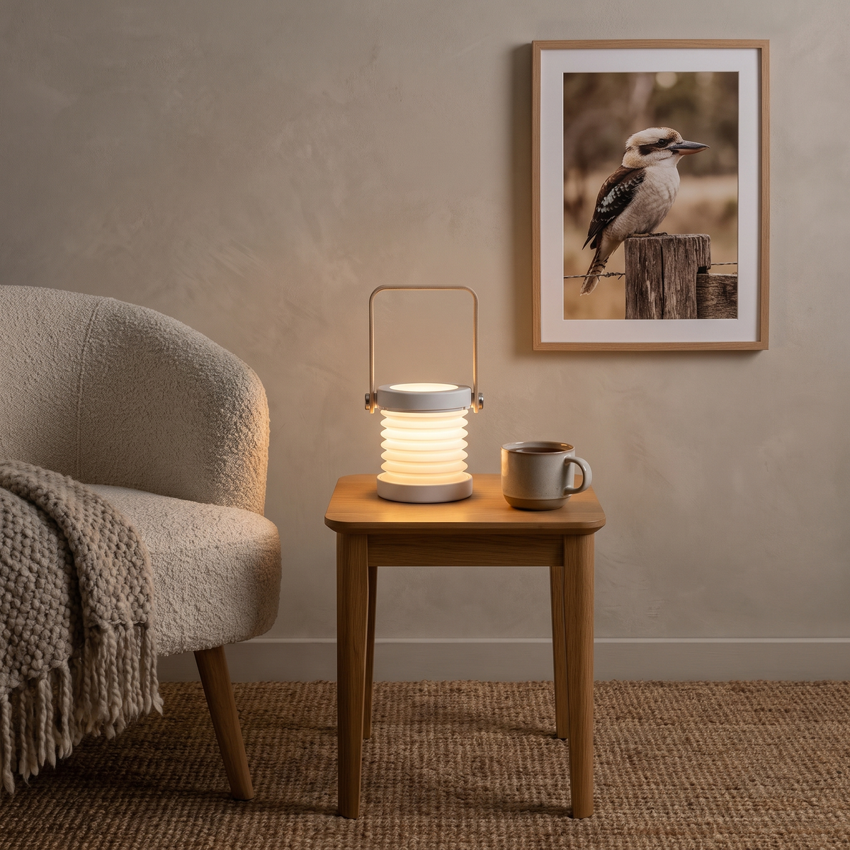 Brae cordless LED lantern in grey on an oak side table in a Scandinavian living room