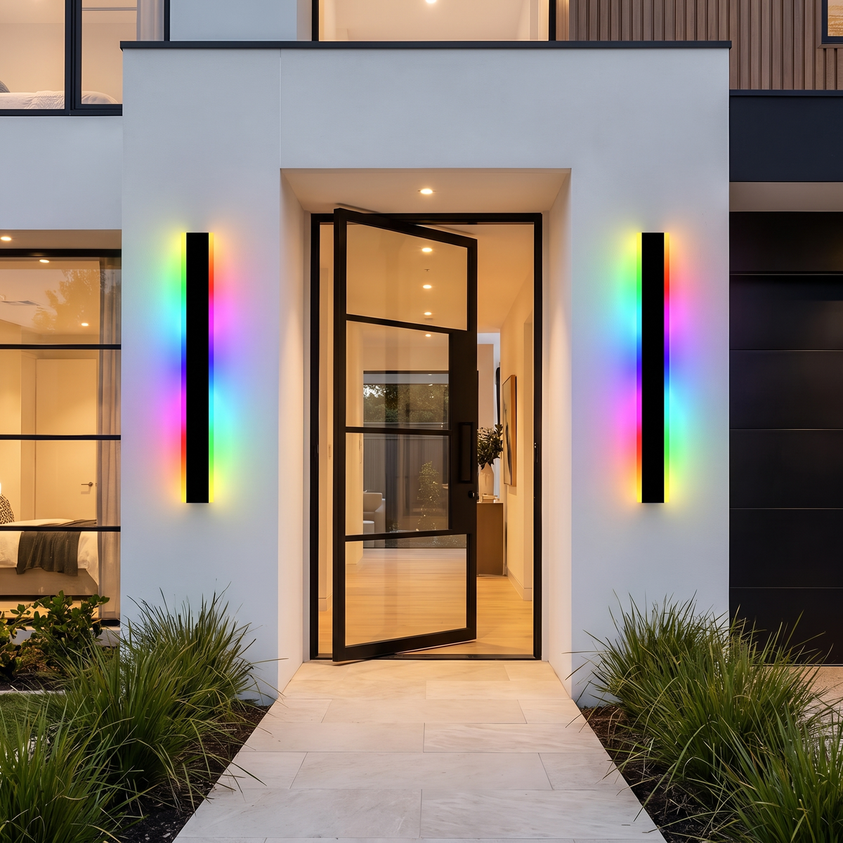 Two 150cm Burdekin RGB LED outdoor wall lights in rainbow colours beside a steel pivot door