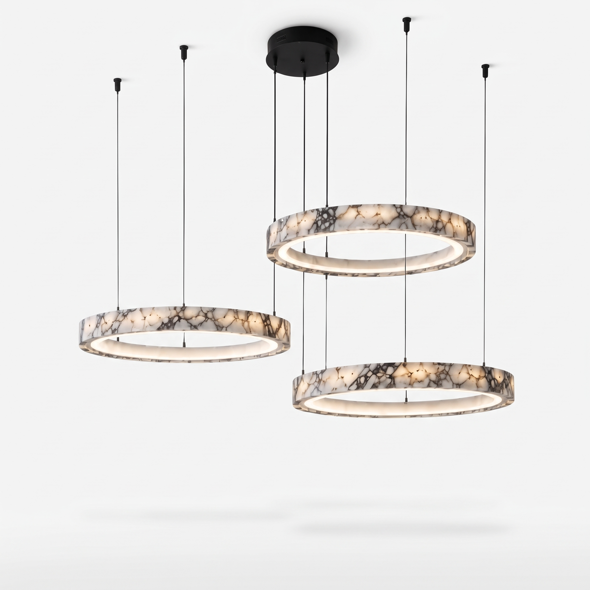 Byron three-ring marble chandelier with staggered rings shown on a plain white background