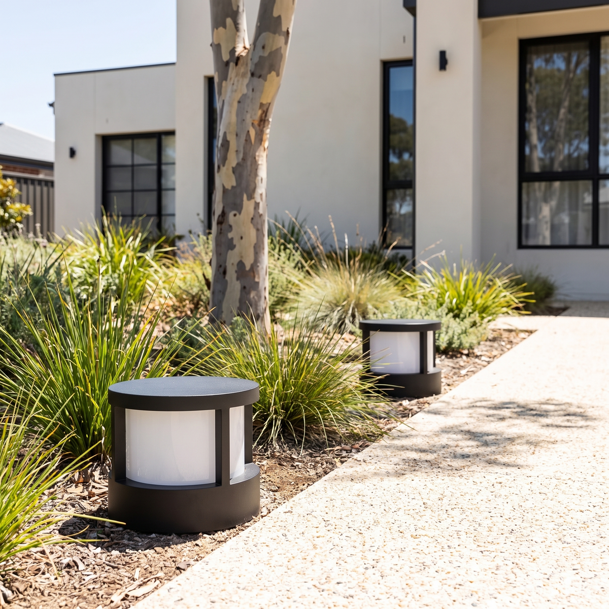 Two Cally LED garden post lights with top lid edging a crushed granite path by a rendered home