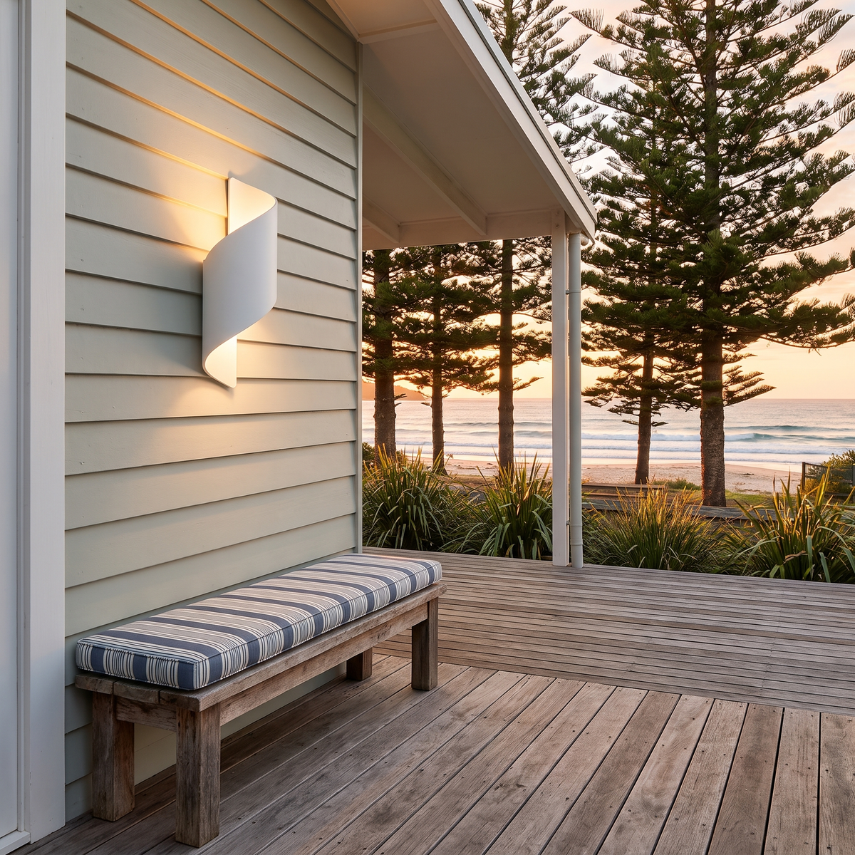 Clarry Outdoor Wall Light in white on a sage weatherboard beach house deck at golden hour