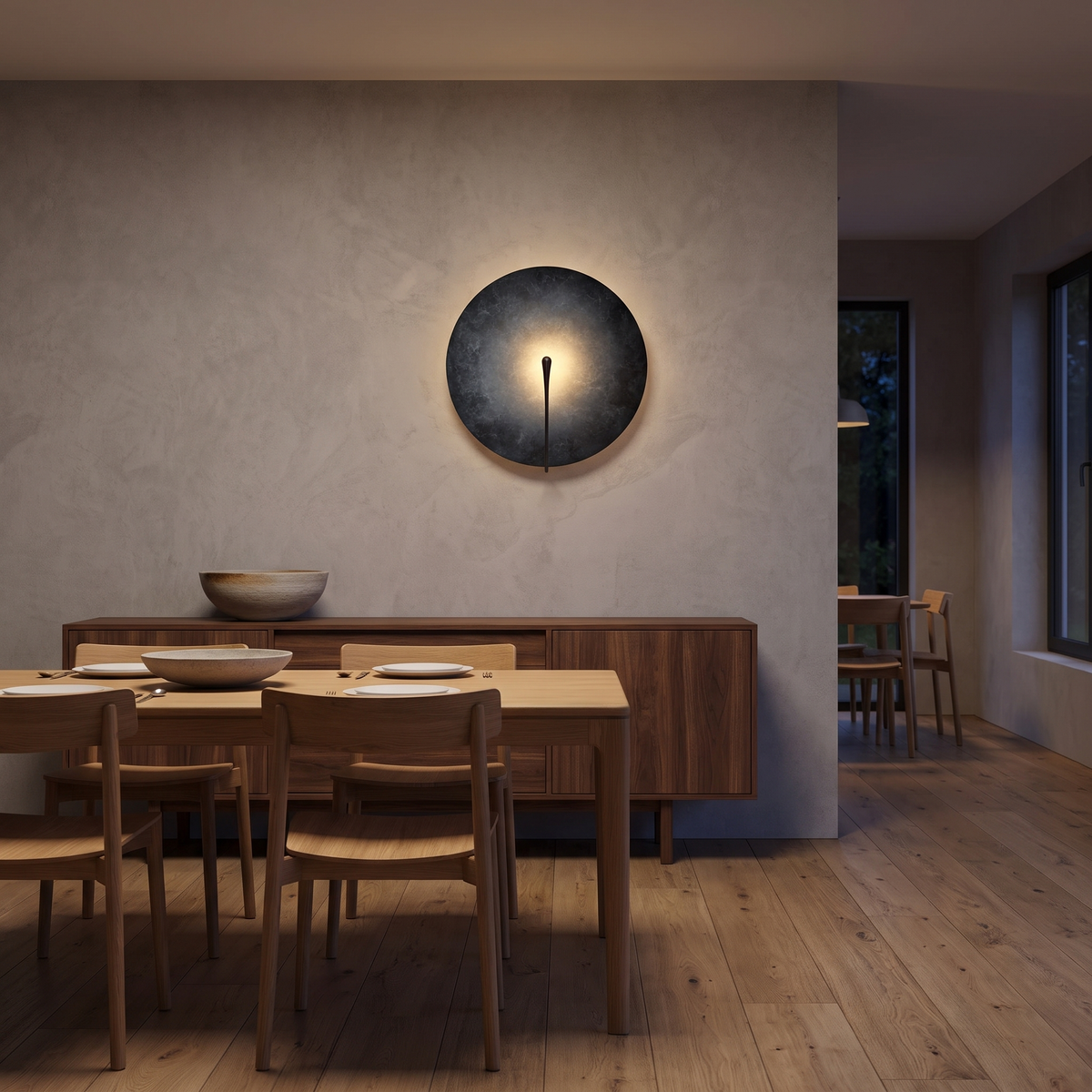Clyde stainless steel round wall light in the dark finish in a dining room