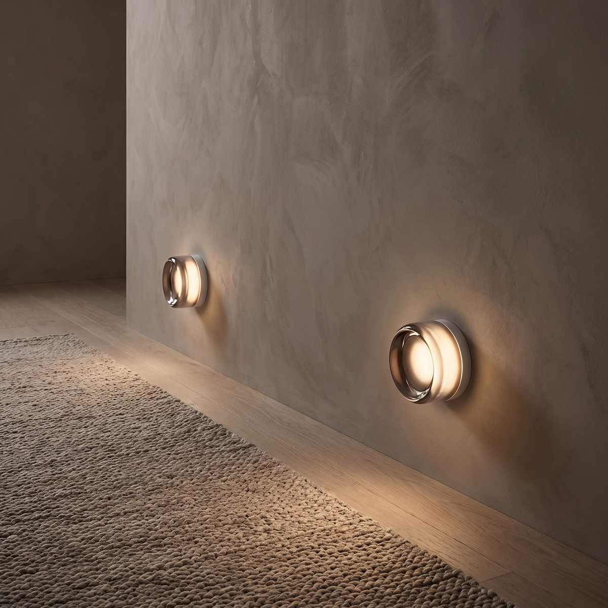 Comu smoky grey dimpled glass sensor wall lights glowing low along a hallway at night
