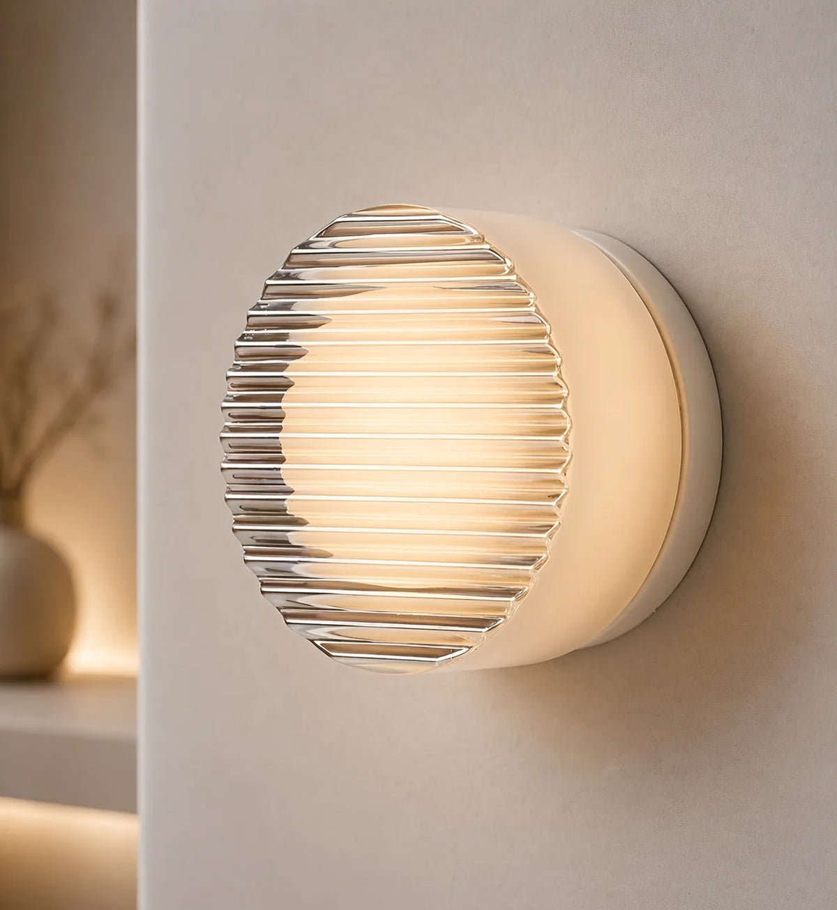Comu white Lines ribbed glass sensor wall light glowing on a pale wall