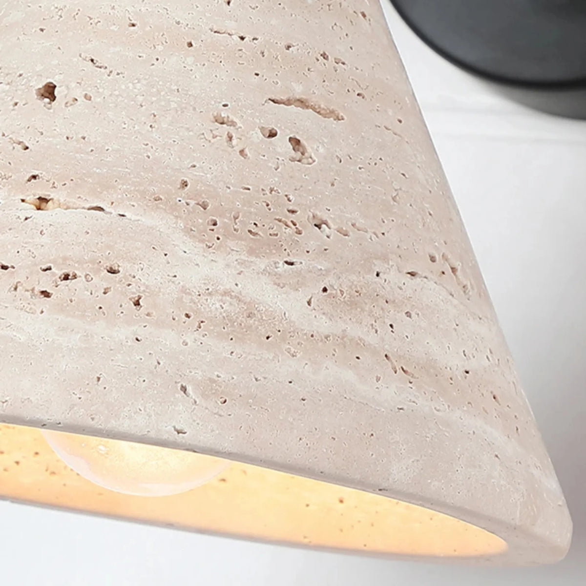 Cromer travertine swing arm wall lamp close-up of the natural travertine cone shade