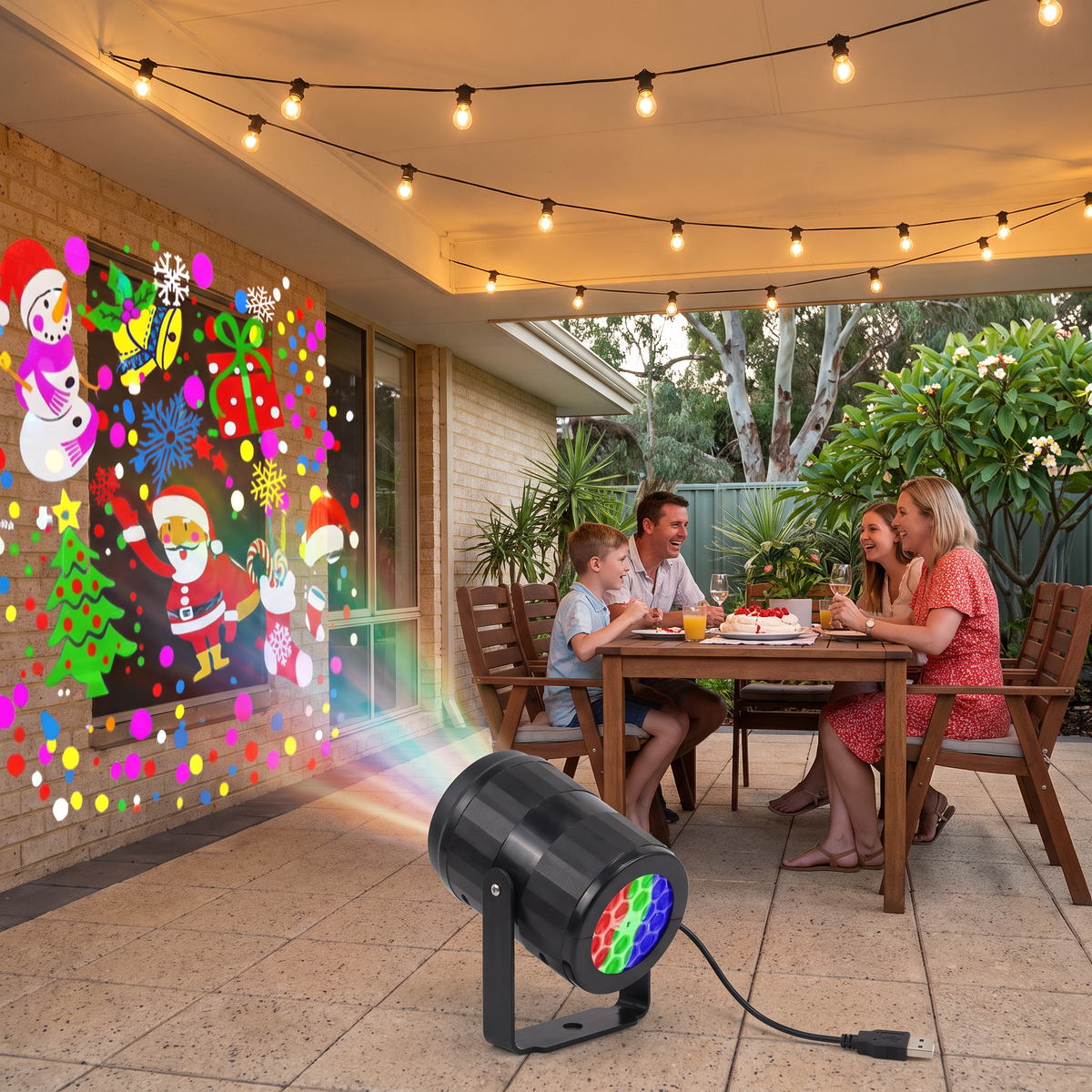 Daria LED Christmas projector on a backyard patio during a family Christmas dinner