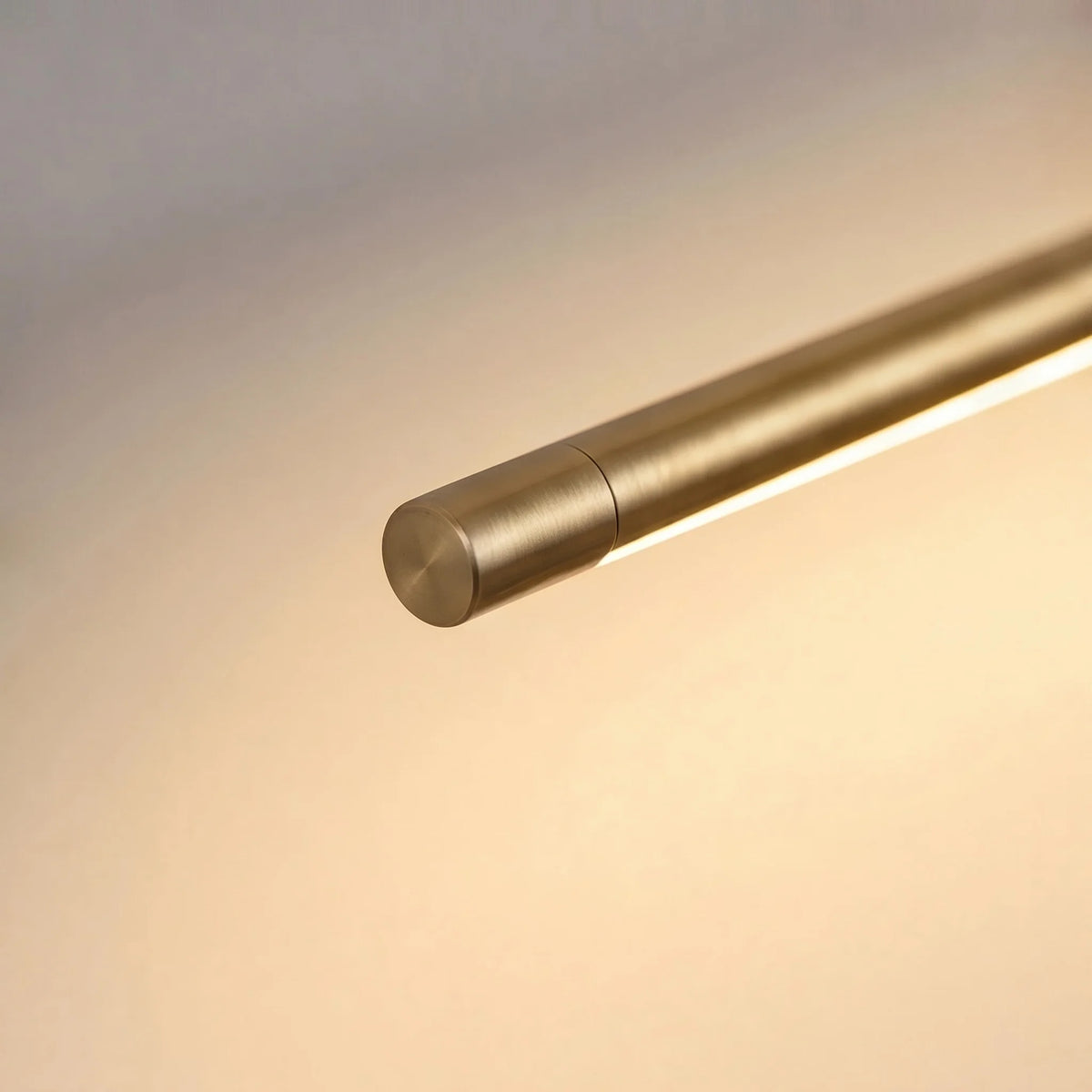 Close-up of the Debi gold rod end cap and its underside LED strip