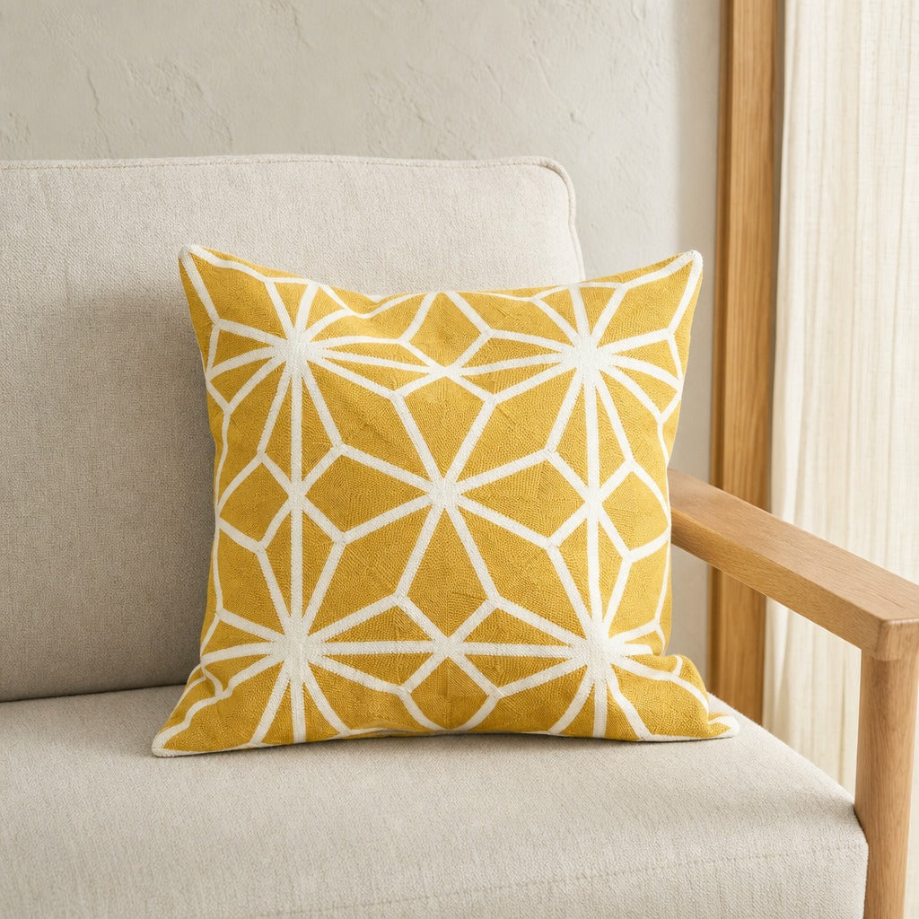 Diamond Tiles golden mustard geometric cushion cover on an oak armchair beside sheer curtains