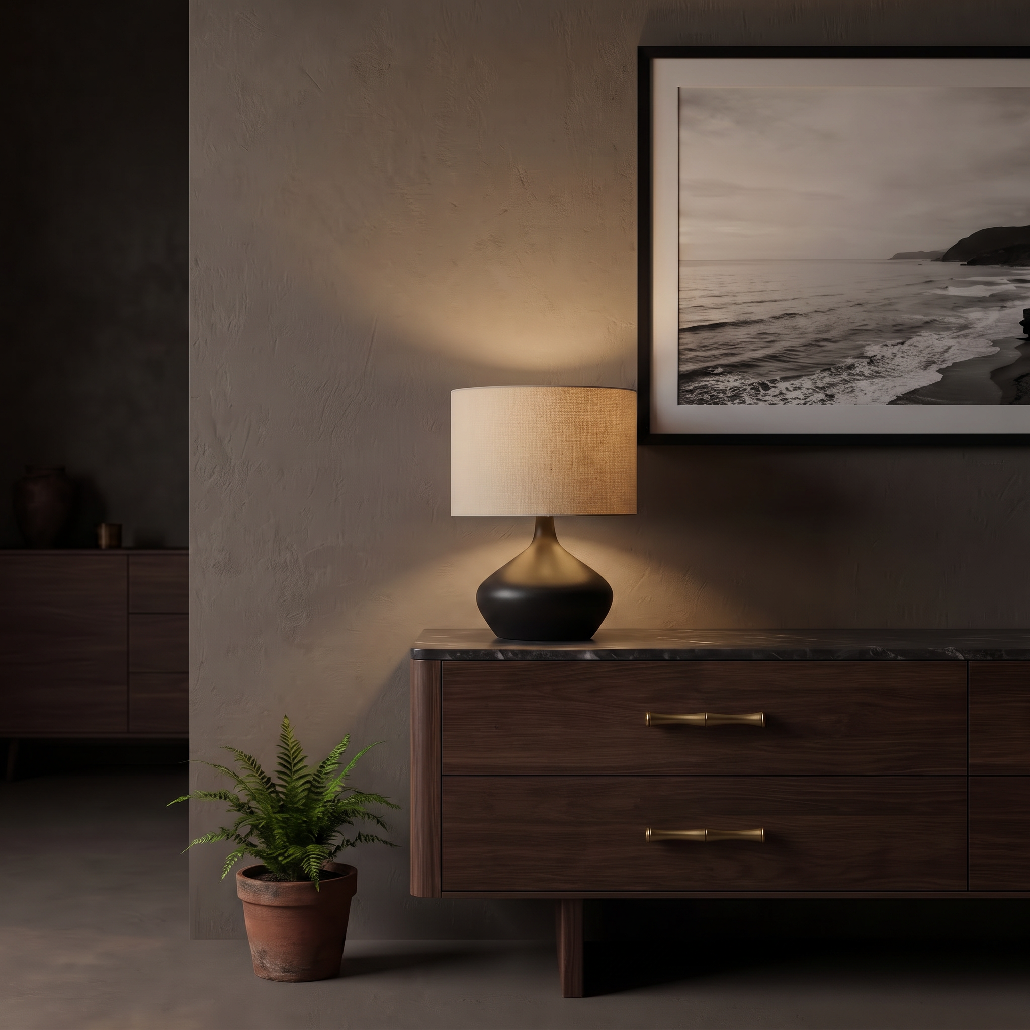 Dune sculptural ceramic table lamp on a dark walnut console fitted with Lucia antique brass handles in a moody, refined living room