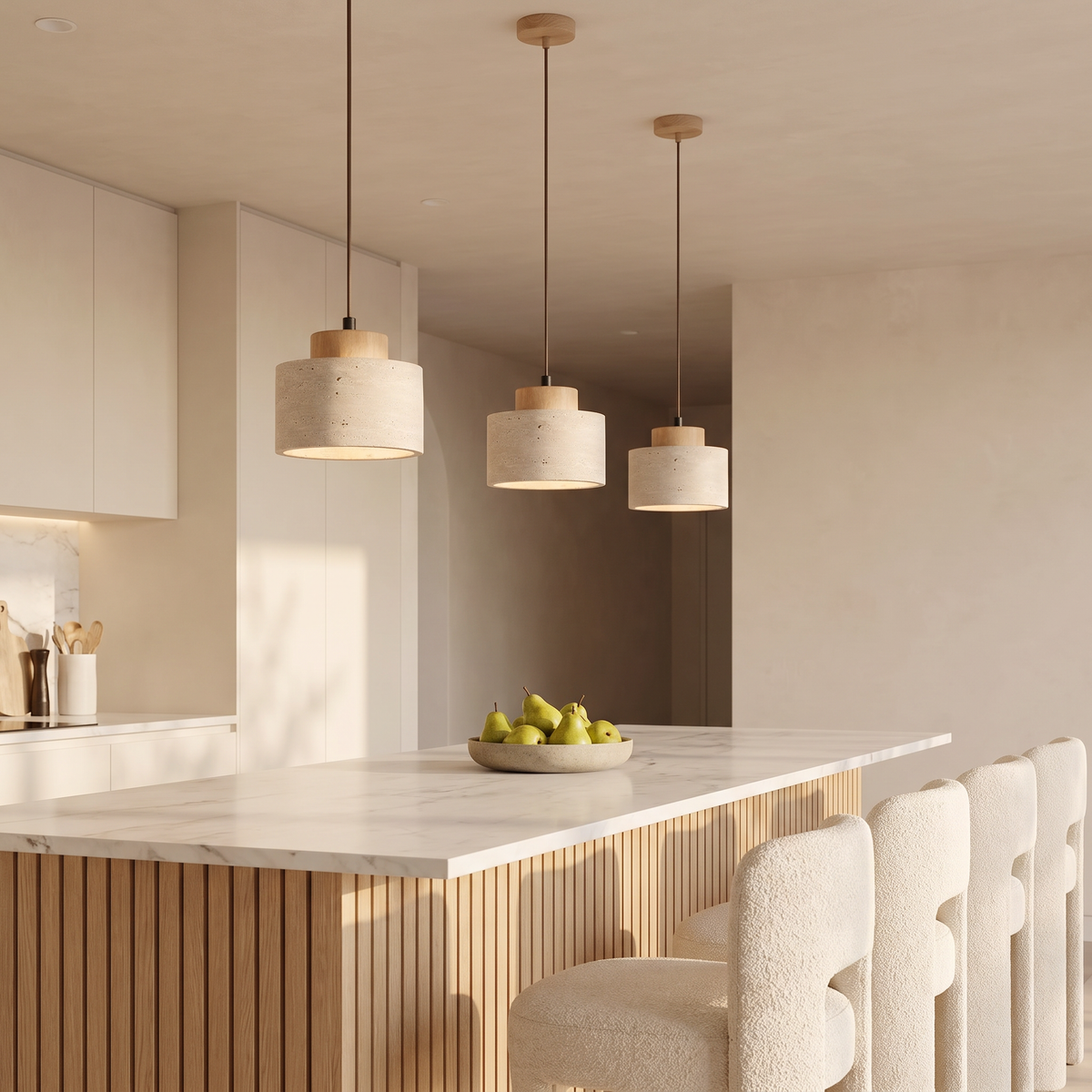 Three Dural short travertine pendants with oak caps over a white marble kitchen island