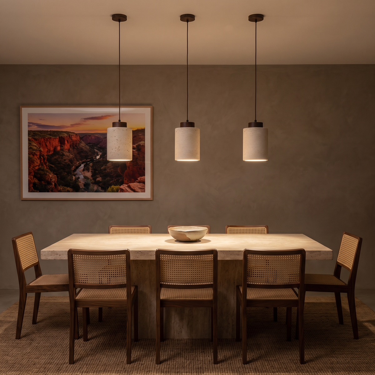 Three Dural tall travertine pendants with walnut caps glowing over a dining table at night