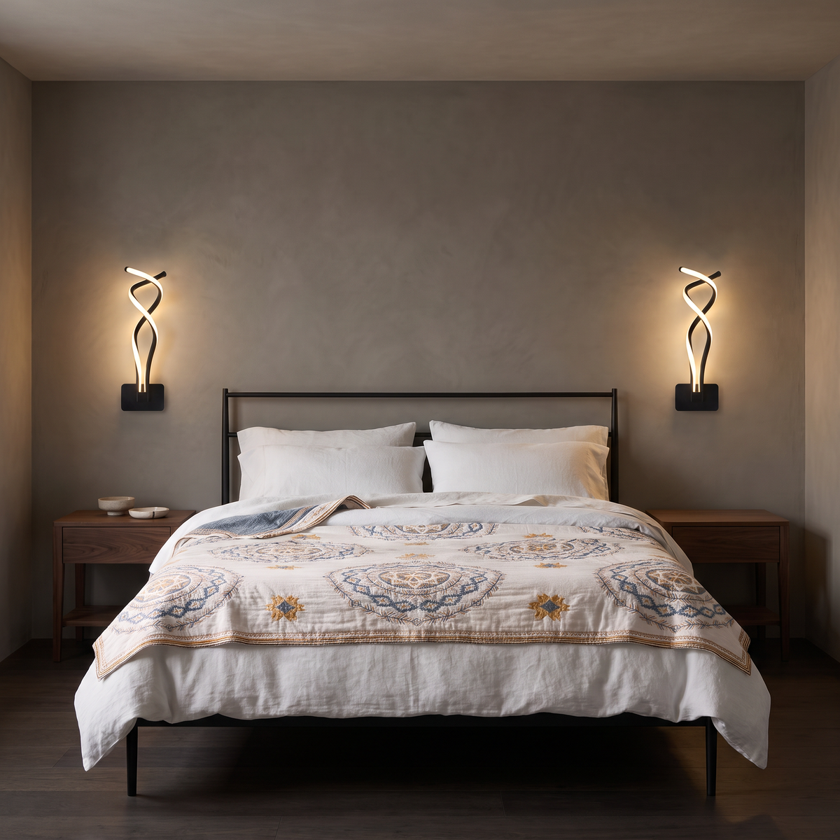 Pair of black Fia LED wall sconces above a bed dressed with a Belle mandala throw