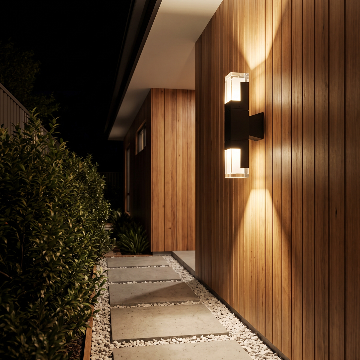 Freo Outdoor Wall Light, 14W up and down, on a blackbutt-clad side path at night