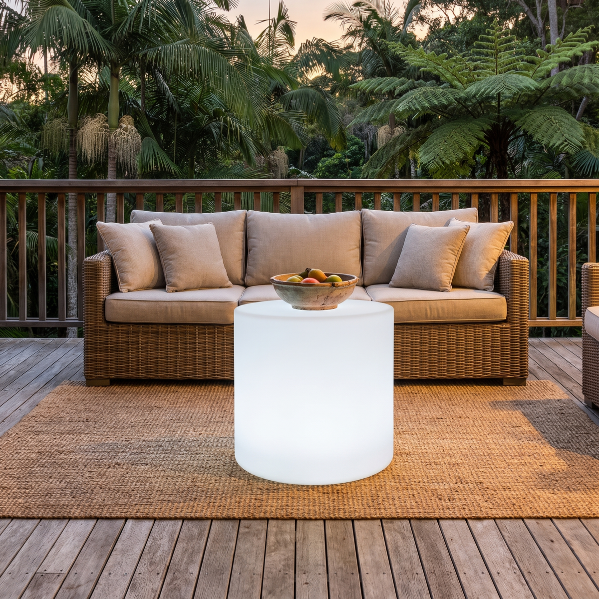 Geri medium LED outdoor coffee table in front of a rattan outdoor sofa on a deck