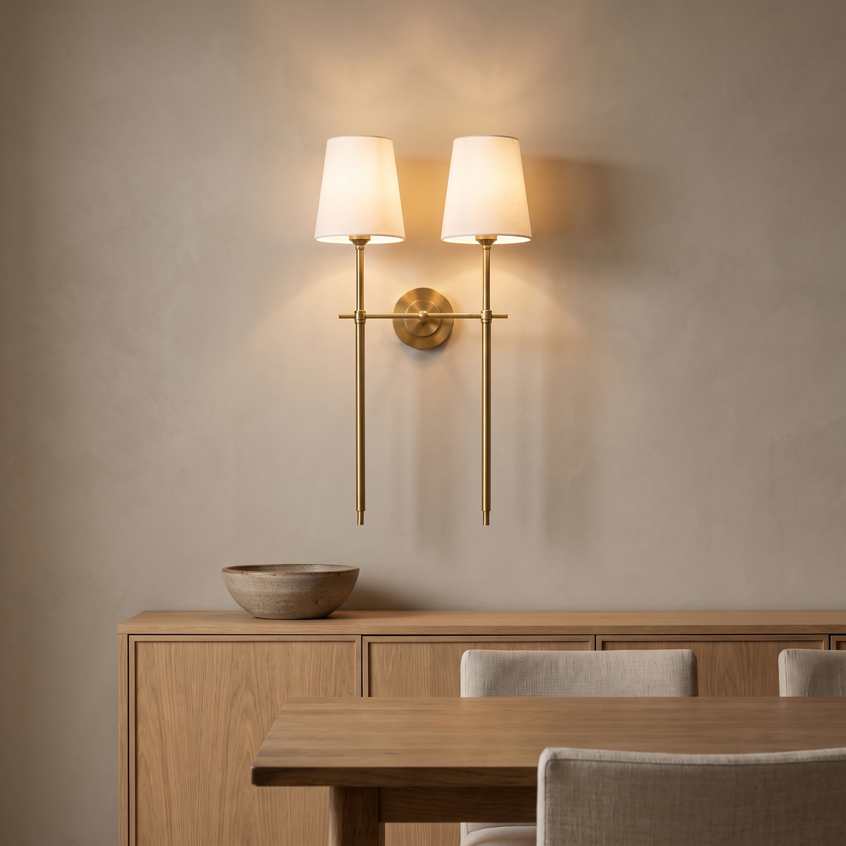 Double Gini brass wall sconce above an oak sideboard in a dining room