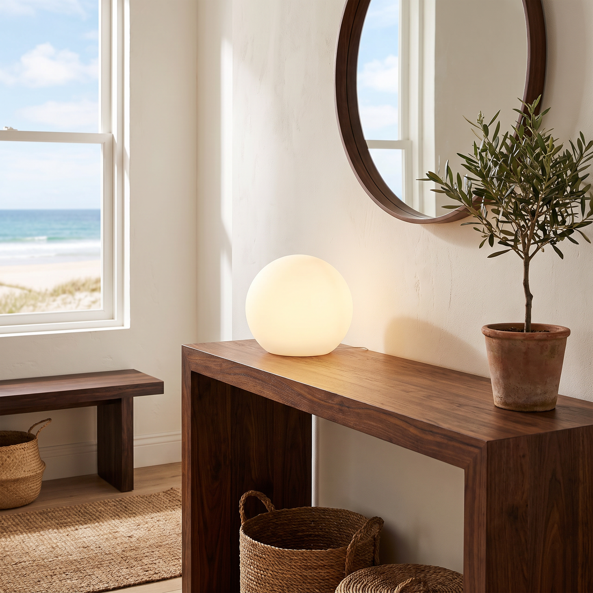 Gondwana portable table lamp on an entryway console with an ocean view in an Australian beach house