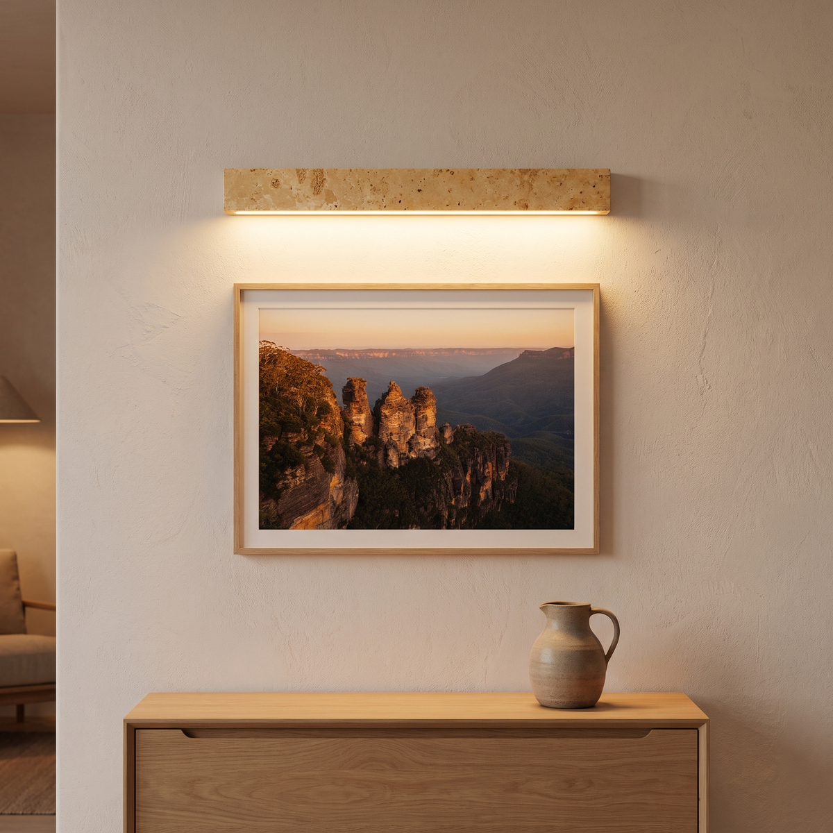 Guru yellow travertine linear LED wall light washing light over Blue Mountains artwork