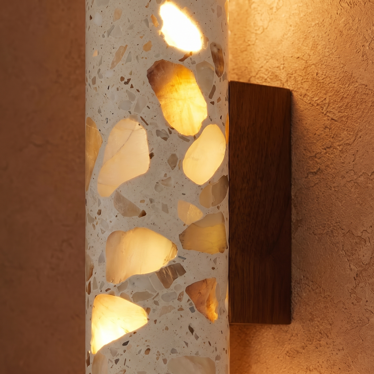 Close-up of glowing stone chips in the Hally terrazzo column with walnut backplate