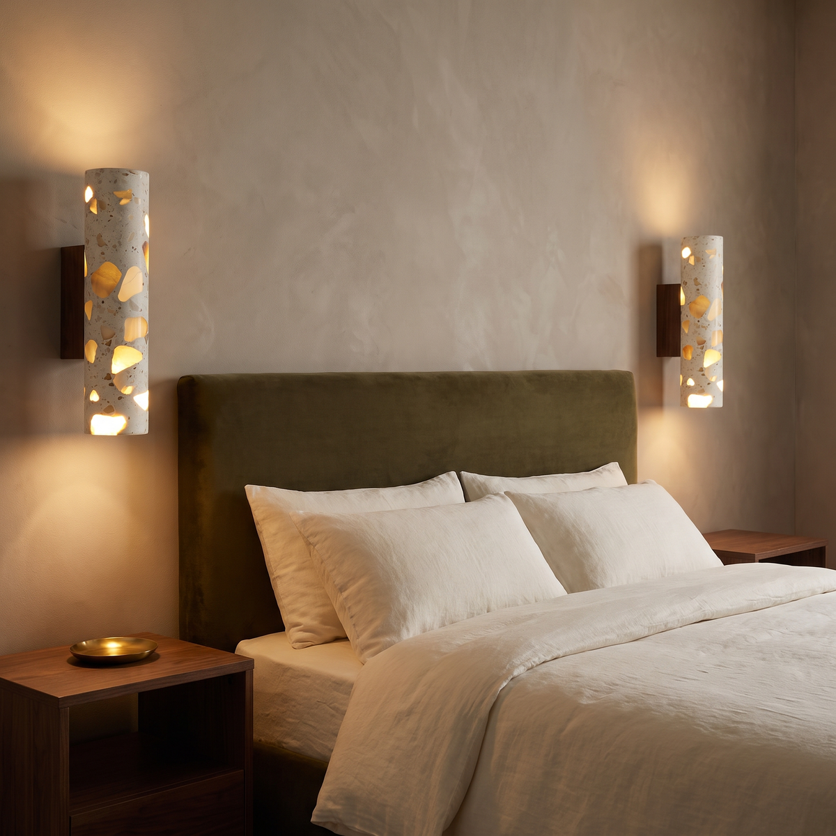 Pair of Hally walnut and terrazzo LED wall lights either side of an olive velvet bed