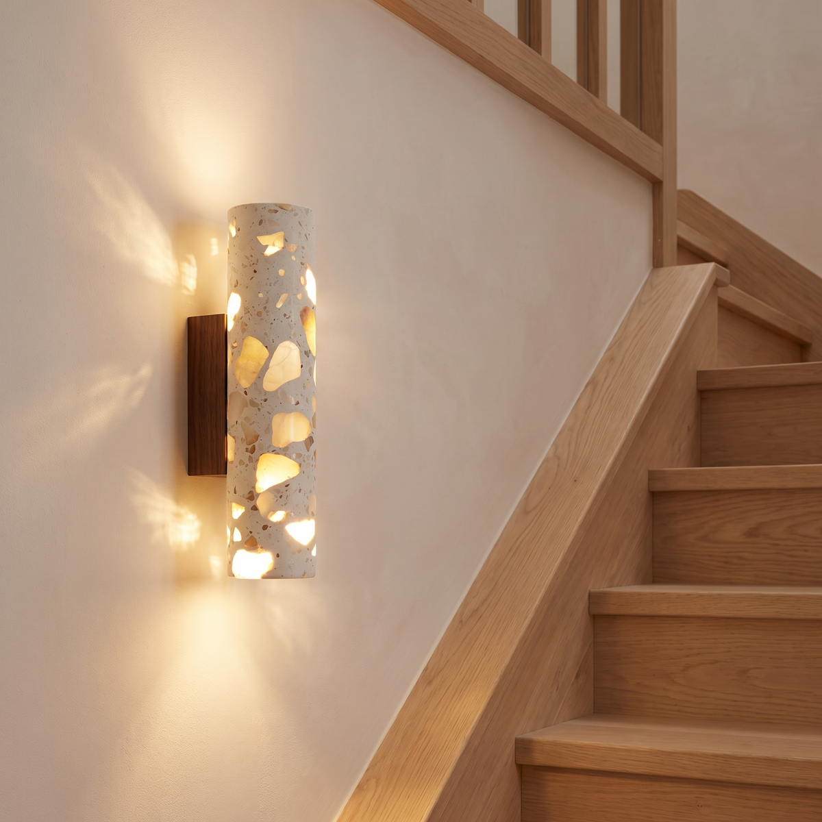 Hally terrazzo LED wall light beside an oak staircase