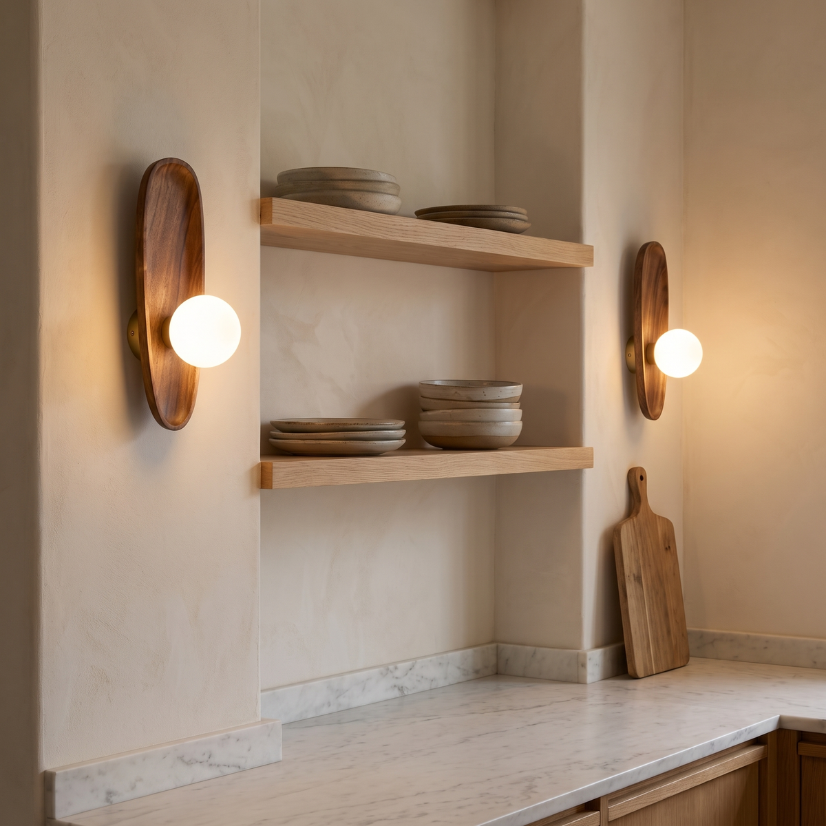 Slim Henny Model B walnut wall lamps either side of open shelves in a marble kitchen