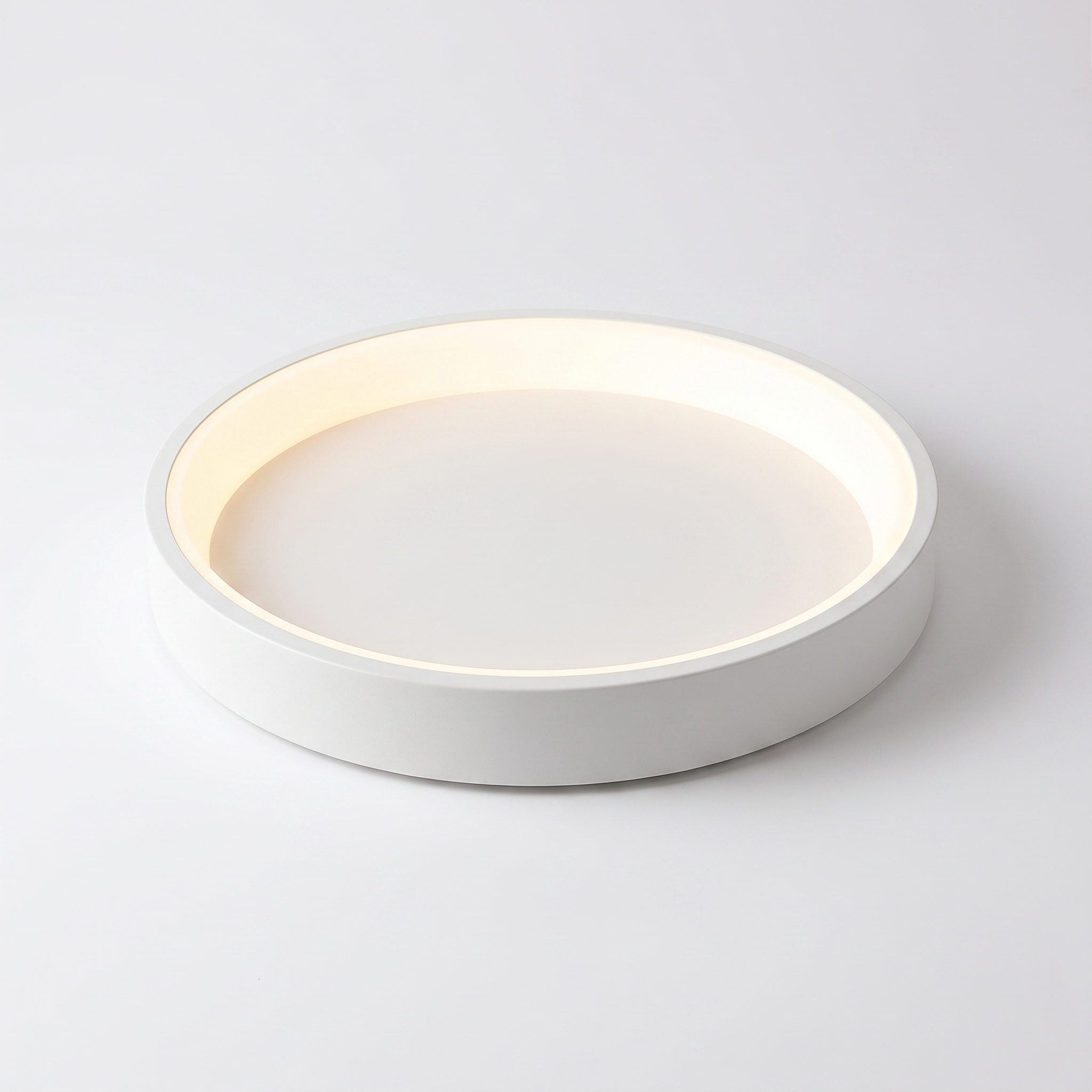 Jilliby LED oyster light in white on a white studio background