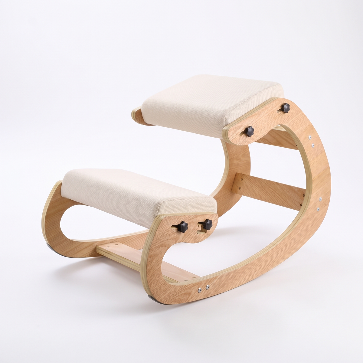 Ivy ergonomic kneeling chair with natural wood frame and cream cushions on a white background
