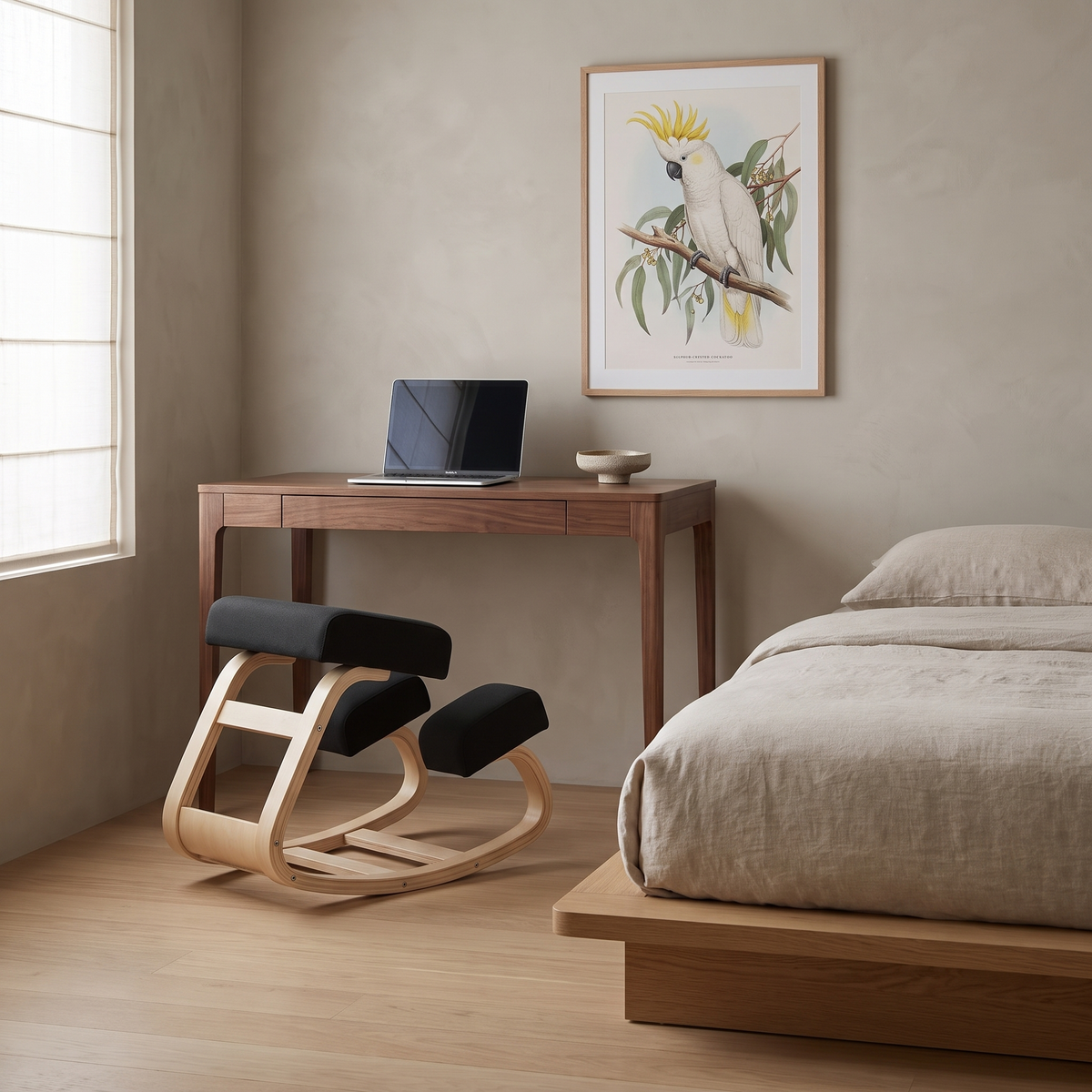 Ivy twin-pad kneeling chair with pale wood frame and black cushions at a walnut desk in a Japandi bedroom