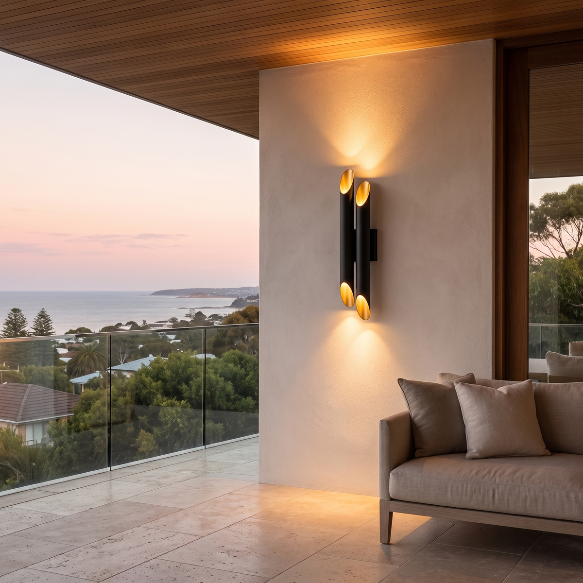 Jarra double-tube steel wall light on a limewashed terrace wall with an ocean view at dusk
