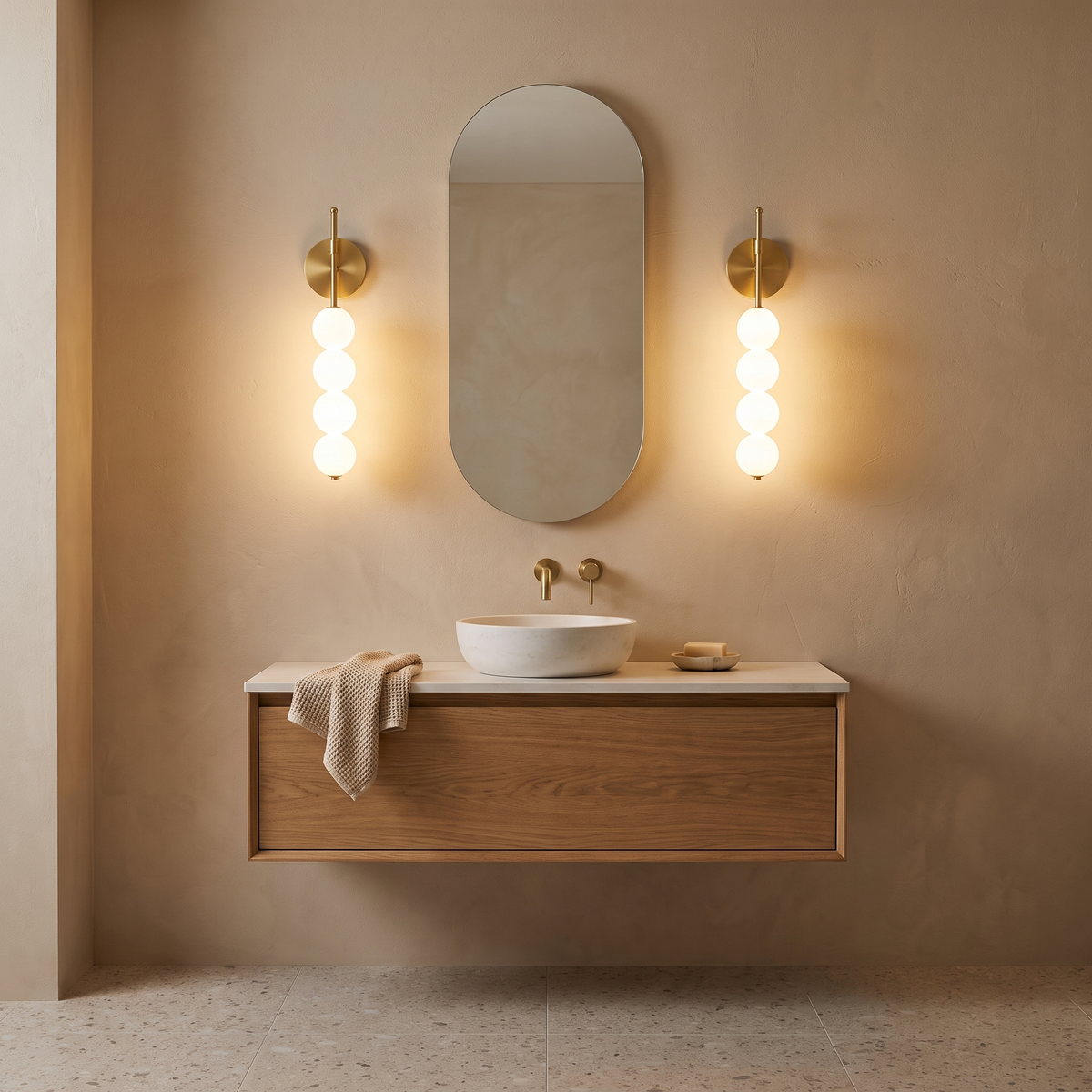 Jilli opal glass wall sconce in gold in a bathroom