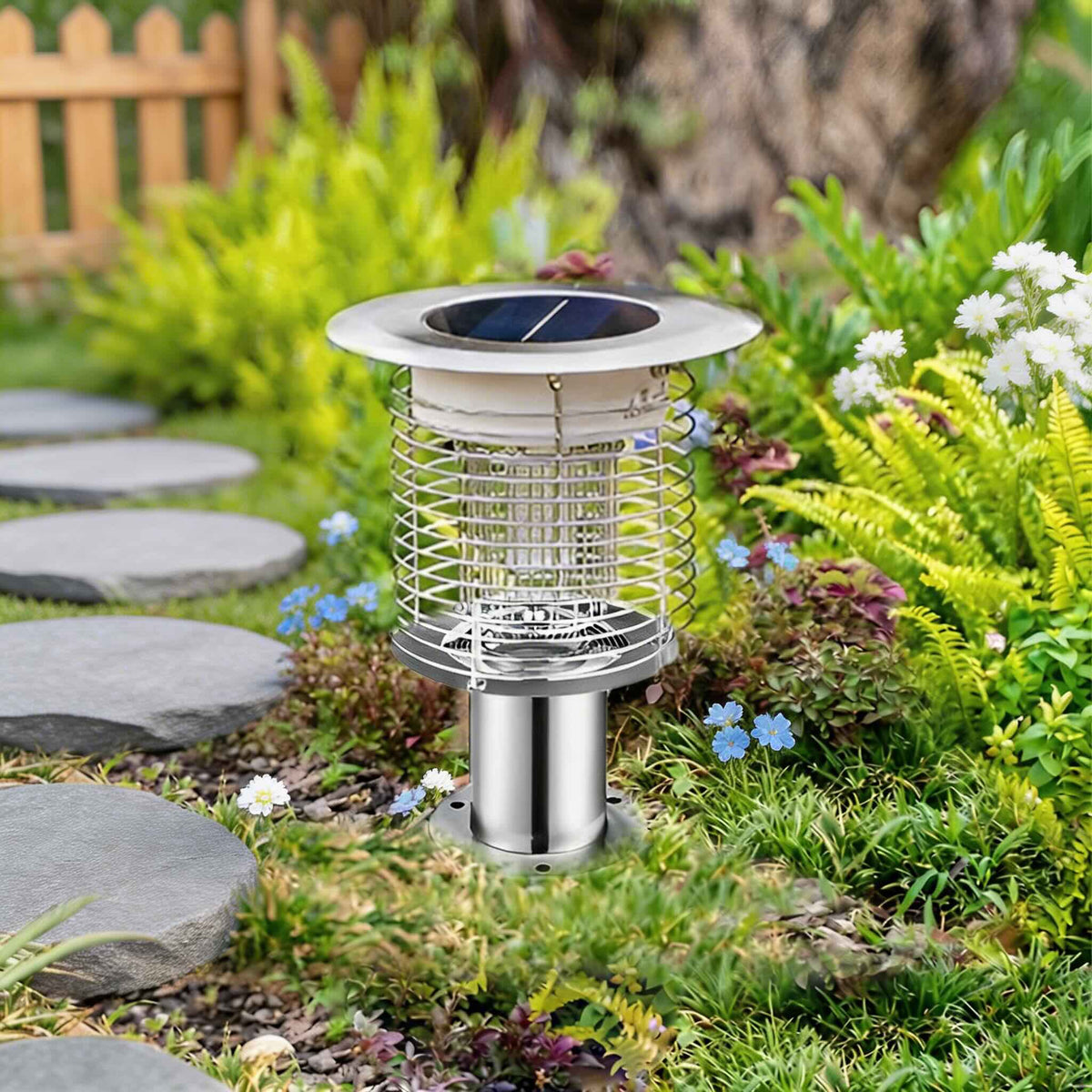 Juli Solar Bug Zapper Pathway Light in silver stainless steel on a post mount beside a stepping stone path