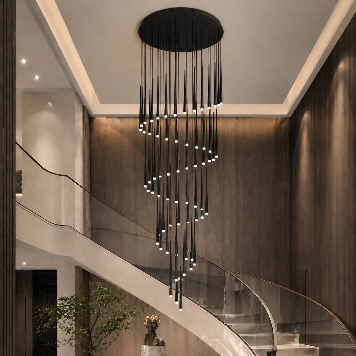Black Jundaru spiral pendant with 25 lights beside a sweeping curved staircase