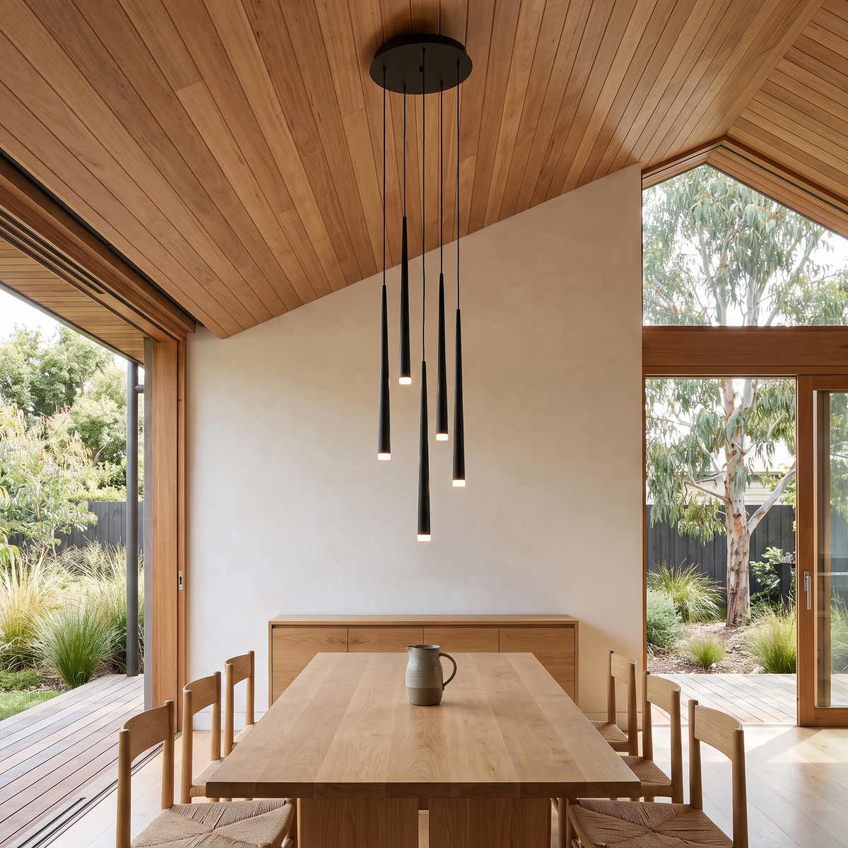 Black six-light Jundaru cluster pendant above an oak dining table in a Japandi dining room