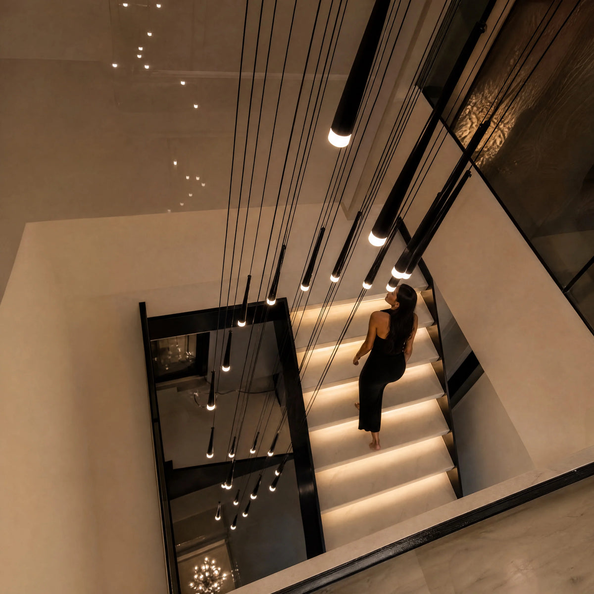 Black Jundaru cluster pendant seen from above dropping through a floating stair void