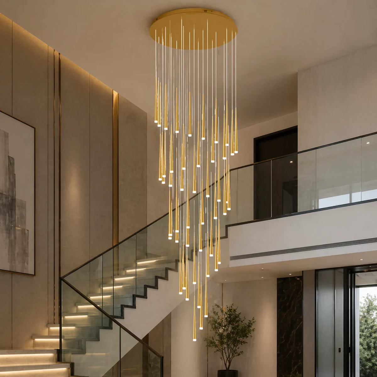 Gold Jundaru cluster pendant with thirty lights beside a glass stair balustrade