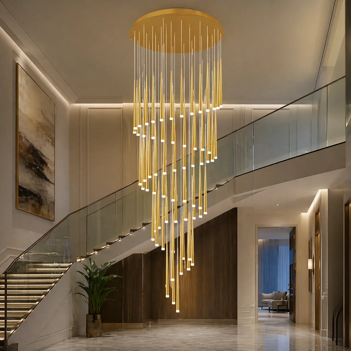 Large gold Jundaru cluster pendant light cascading through a glass-balustrade stairwell