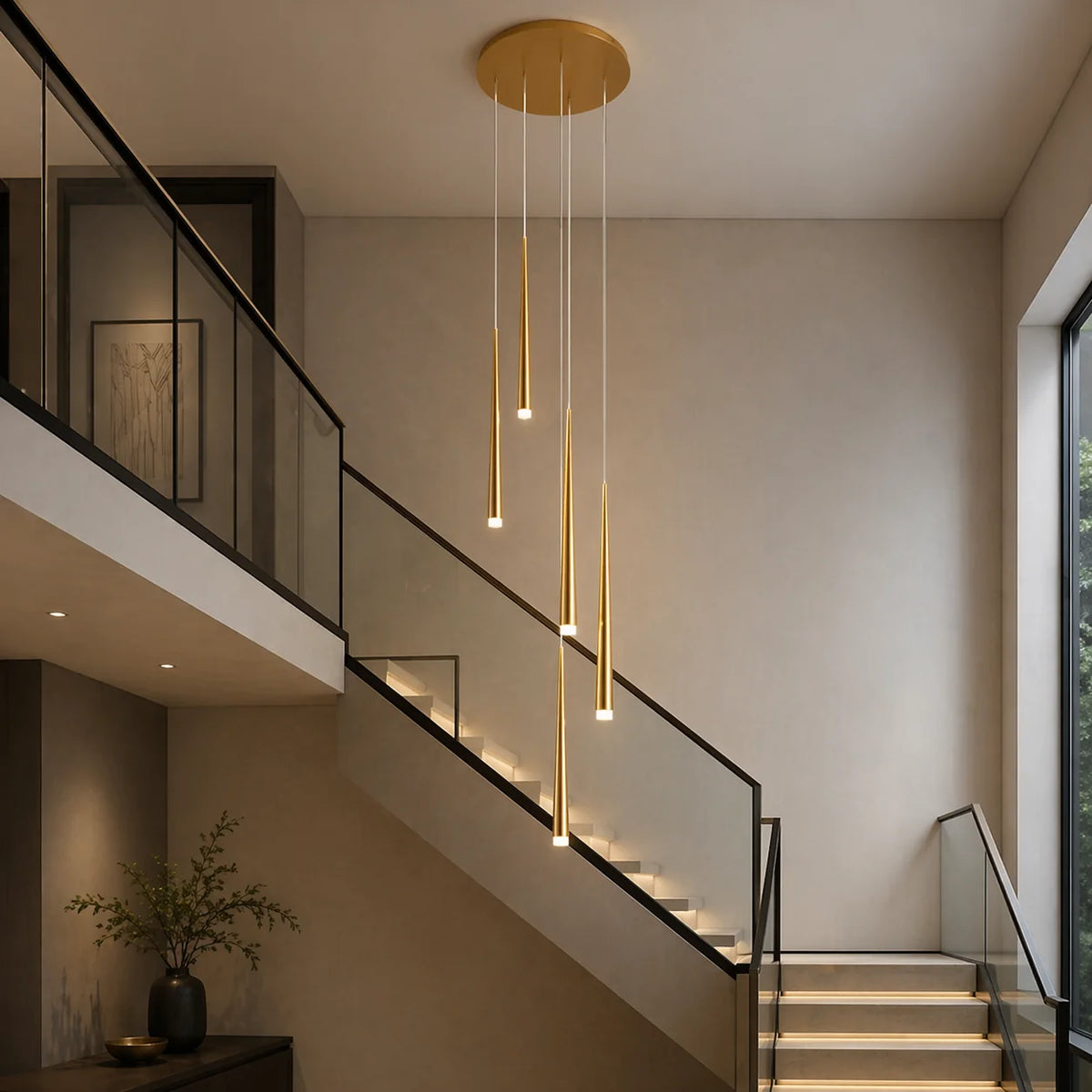 Gold Jundaru cluster pendant with six lights in a modern stairwell with lit stair treads