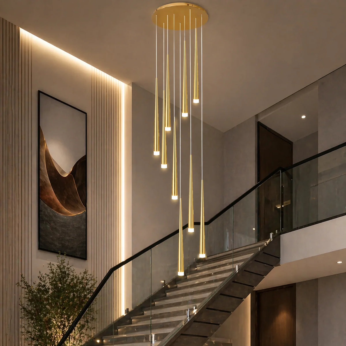 Gold Jundaru nine-light cluster pendant in a stairwell with a lit feature wall