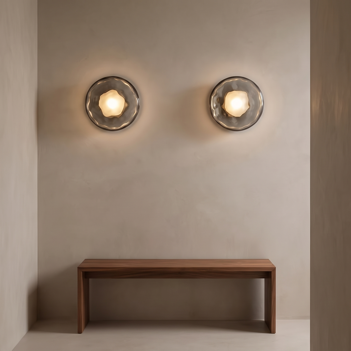 Pair of Kevi smoke grey flush round wall lights above a walnut bench