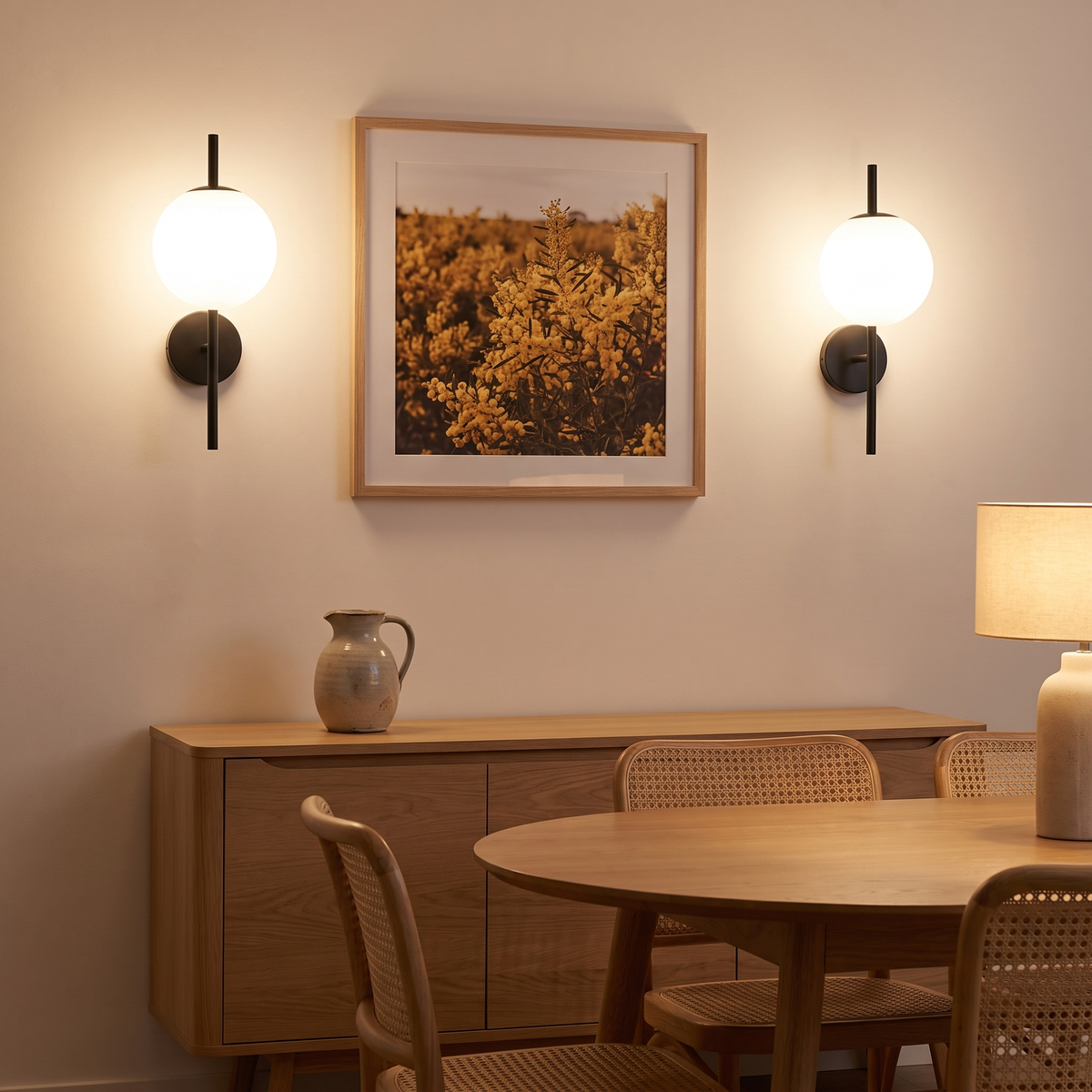 Pair of Kevi white glass wall lights on black rods in a dining room