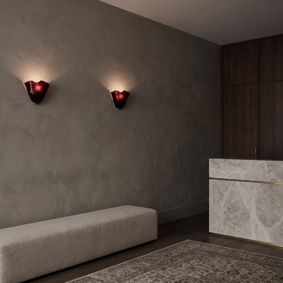 Pair of Kira artistic wall sconces in burgundy glass lit in a boutique hotel lounge