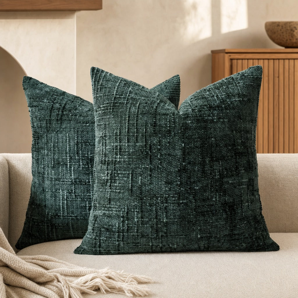 Lucina chenille throw pillows in dark green on a sofa in front of a fluted timber sideboard