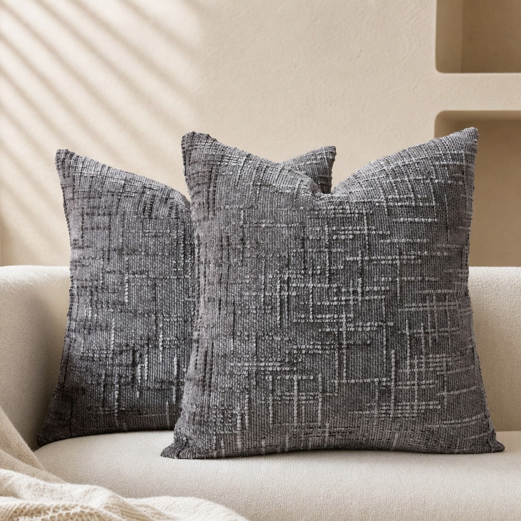 Lucina chenille throw pillows in grey with a textured bamboo weave on a cream sofa