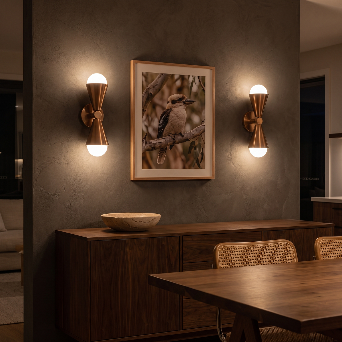 Pair of Lura copper wall sconces flanking artwork above a walnut sideboard in a dining room