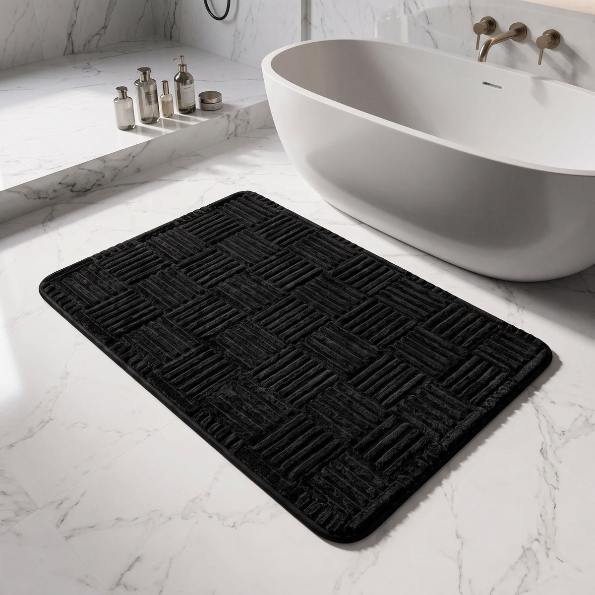 Marden striped non-slip bath mat in black on a white marble floor beside a freestanding bath