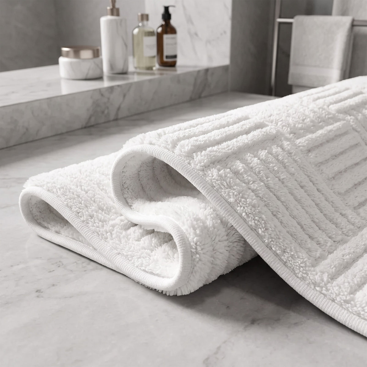 Rolled Marden striped bath mat in white showing its soft, thick embossed pile up close