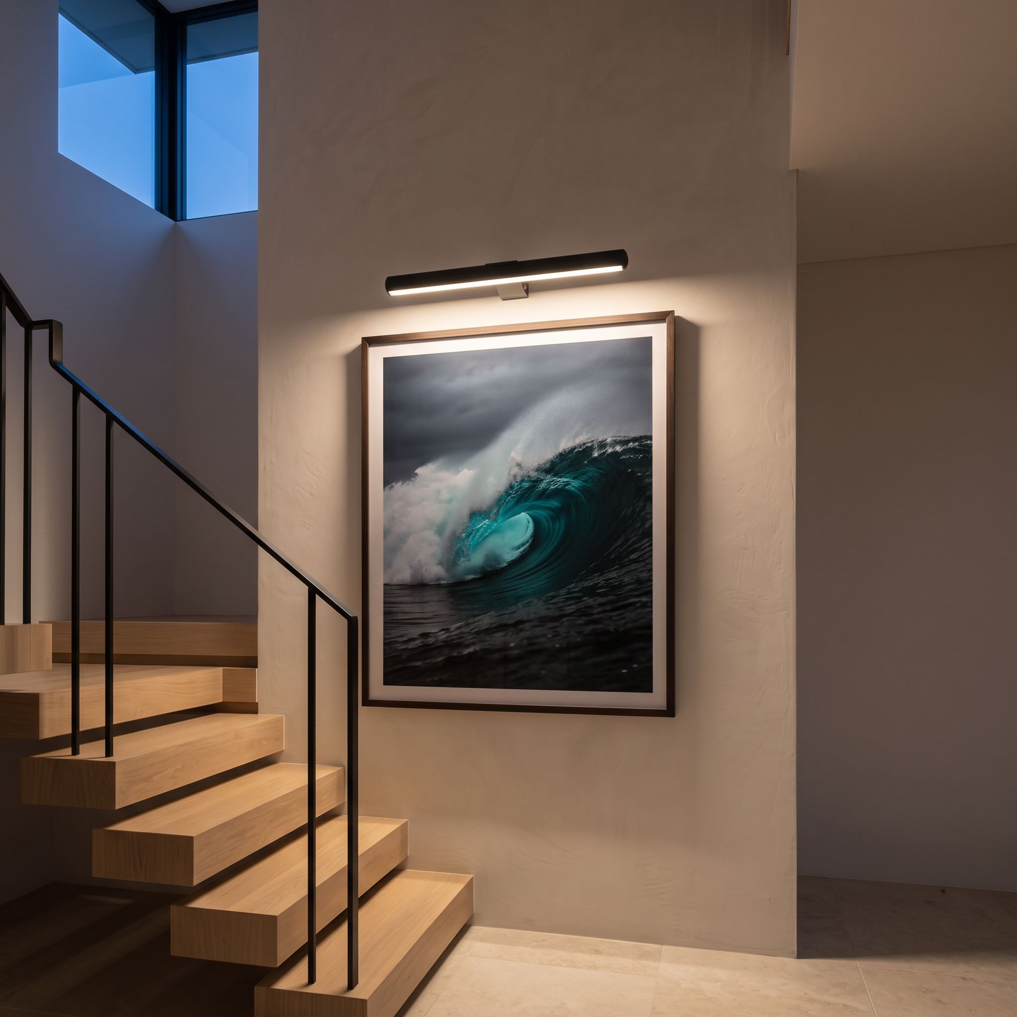 Marley cordless rechargeable picture light in Black lighting a framed wave photograph on a stair landing wall