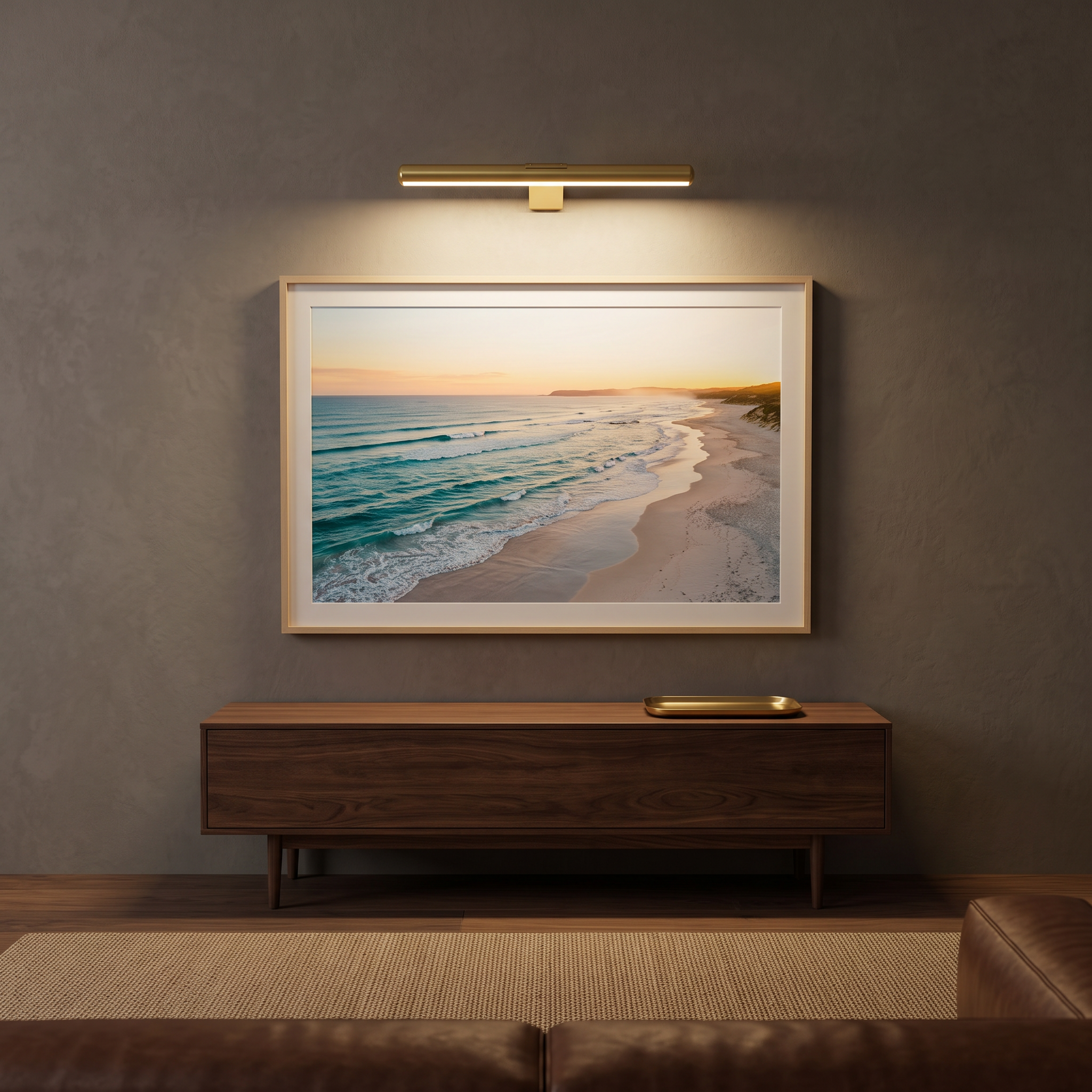 Marley cordless rechargeable picture light in Gold lighting a framed coastal painting in a living room